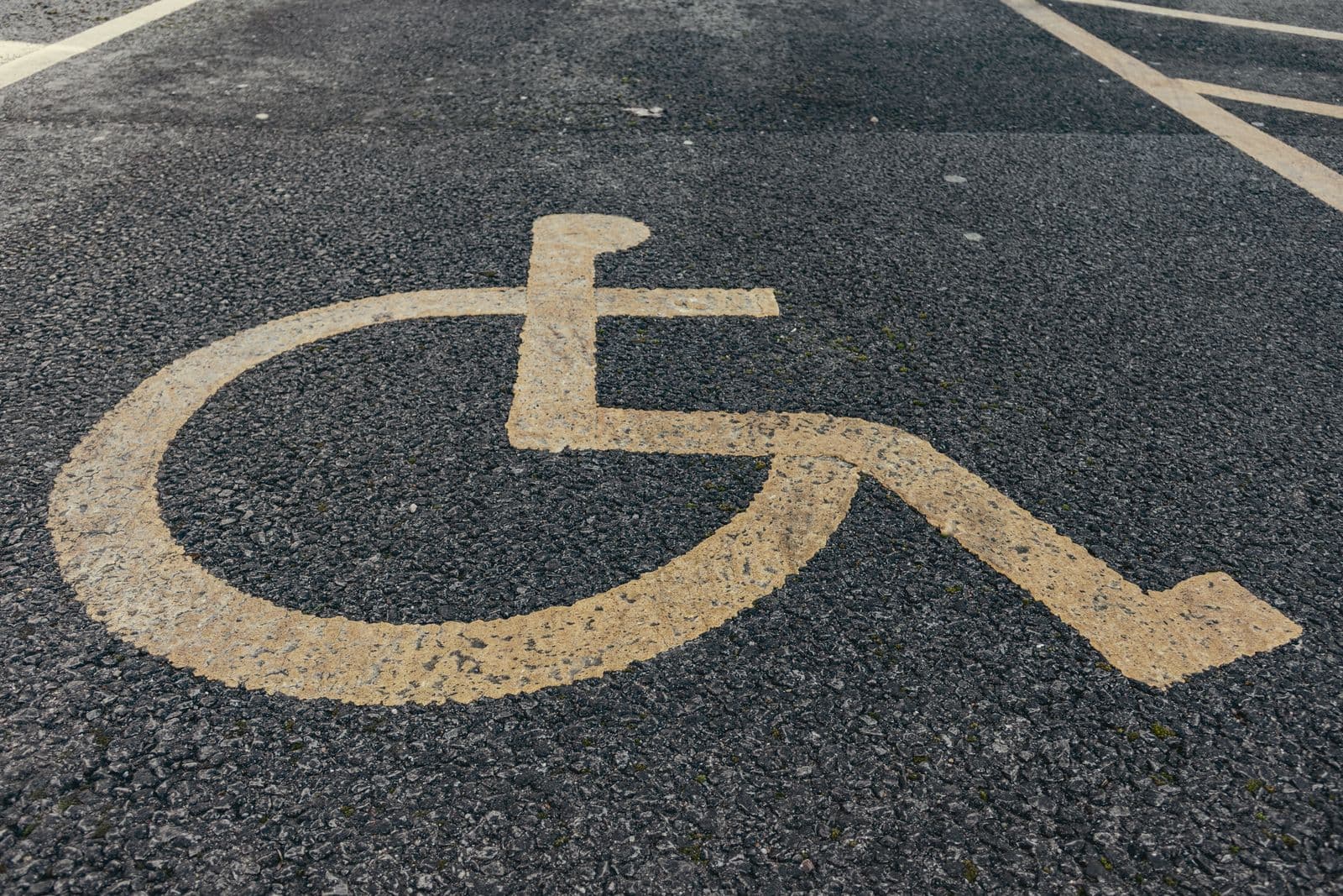 Marquage fauteuil roulant peint sur une place de stationnement